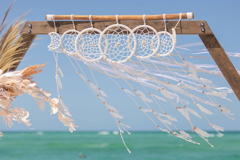 Boho arch with hanging macramé dreamcatchers by the Gulf near Sarasota